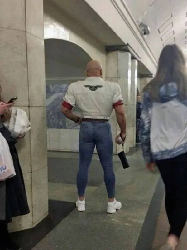 Funny meme photo of a muscular man wearing an extremely tight cropped outfit.