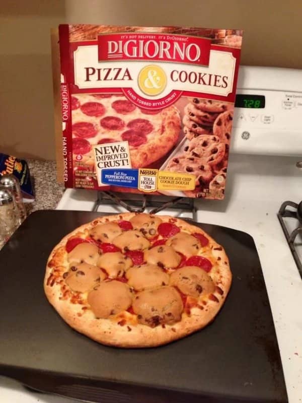 Baked pizza topped with whole chocolate chip cookies cooked directly into cheese.