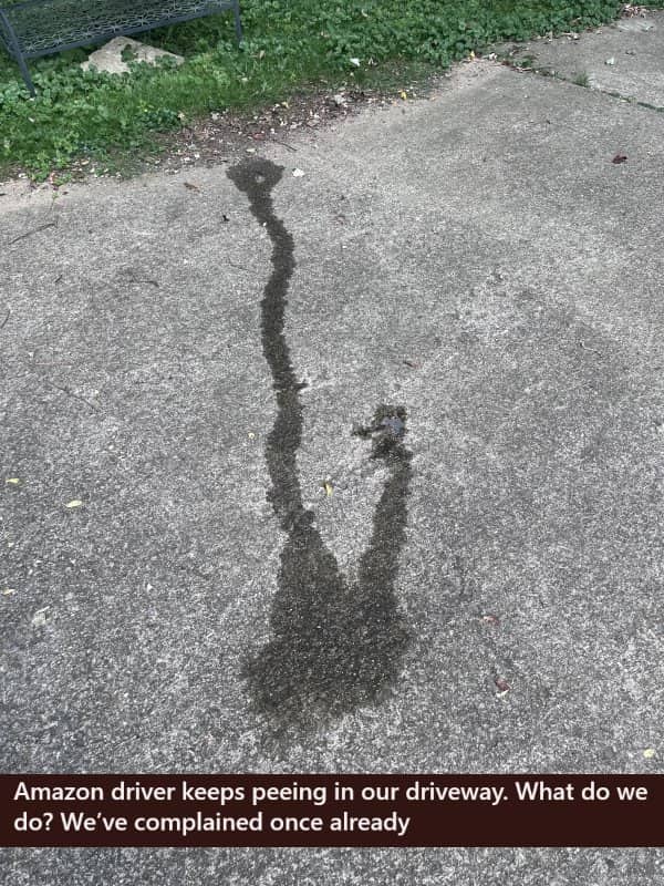 Puddle on a driveway left by an Amazon delivery driver causing a bad day.