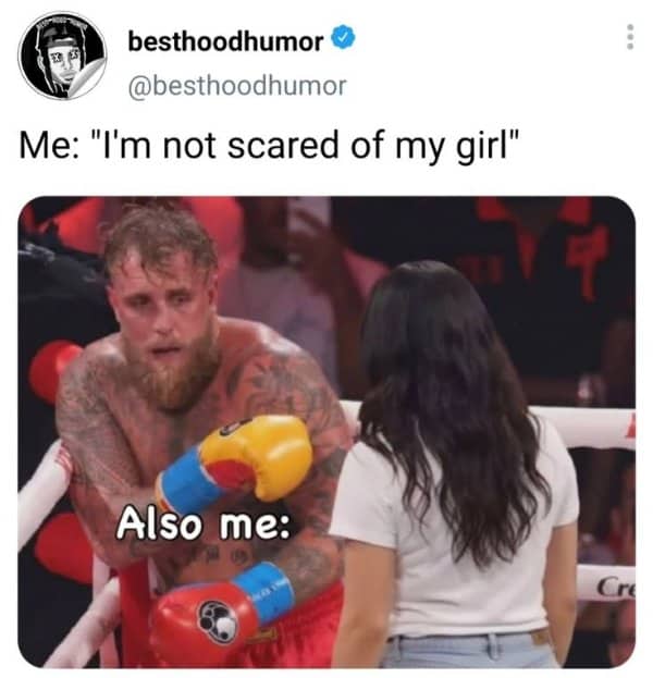 Tough boxer clings to his girlfriend in the ring, a classic marriage memes reversal.