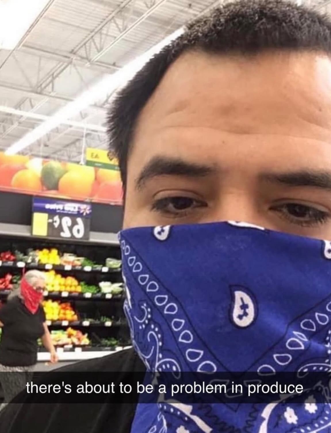 Grocery store selfie of a man in a blue bandana spotting another shopper in a red bandana in the produce section in a meme dump.