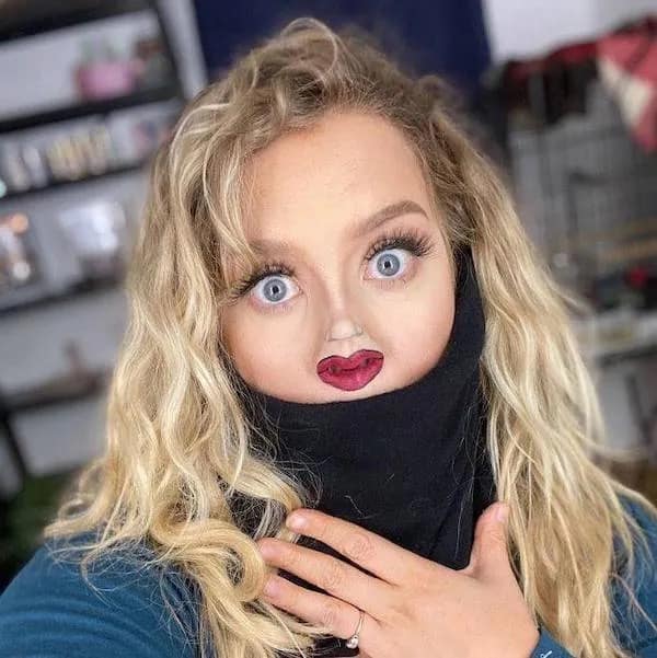 Hilarious photo of a woman pulling her black turtleneck over her chin to create a distorted mini-face in a hilarious memes selection.