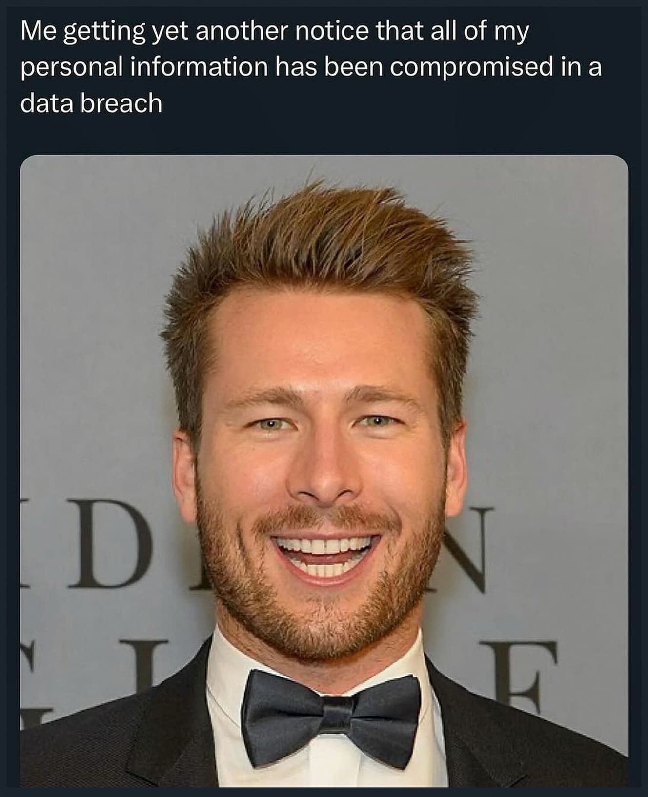 Strained, unnaturally frozen smile on actor Glen Powell in a tuxedo, paired with text about receiving another data breach notice in a meme dump.