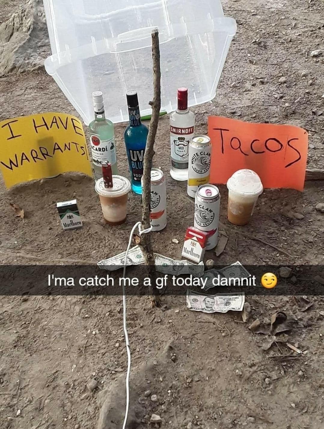 Outdoor box-and-stick trap baited with White Claws, hard liquor, iced coffee, and Marlboros in a meme dump.