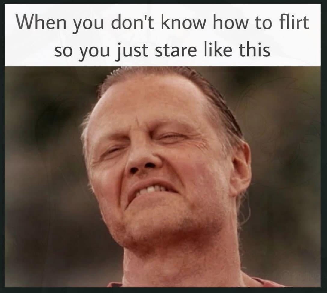 Man squinting and grimacing like someone who has no idea how to flirt.