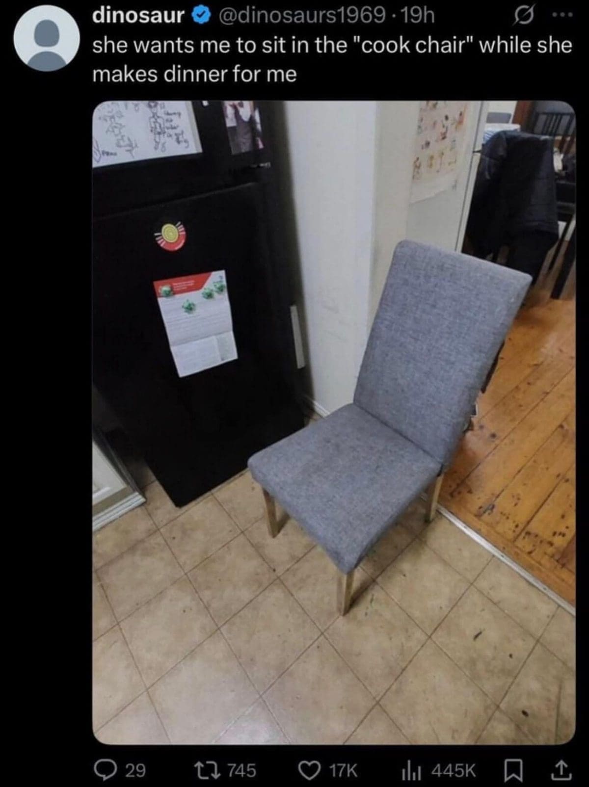 Lone gray chair in a kitchen corner, jokingly called the cook chair.