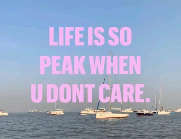 Serene ocean view with sailboats overlaid with bright pink motivational text about life being peak when you stop caring in a meme dump.