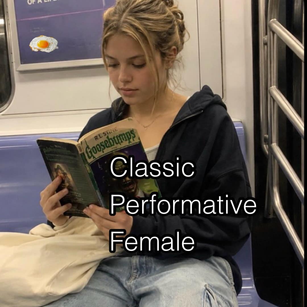 Subway passenger quietly absorbed in an original Goosebumps paperback book, sarcastically captioned 'Classic Performative Female' in a meme dump.