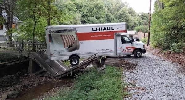 Funny accident photo meme showing a U-Haul truck stuck on a collapsed bridge.