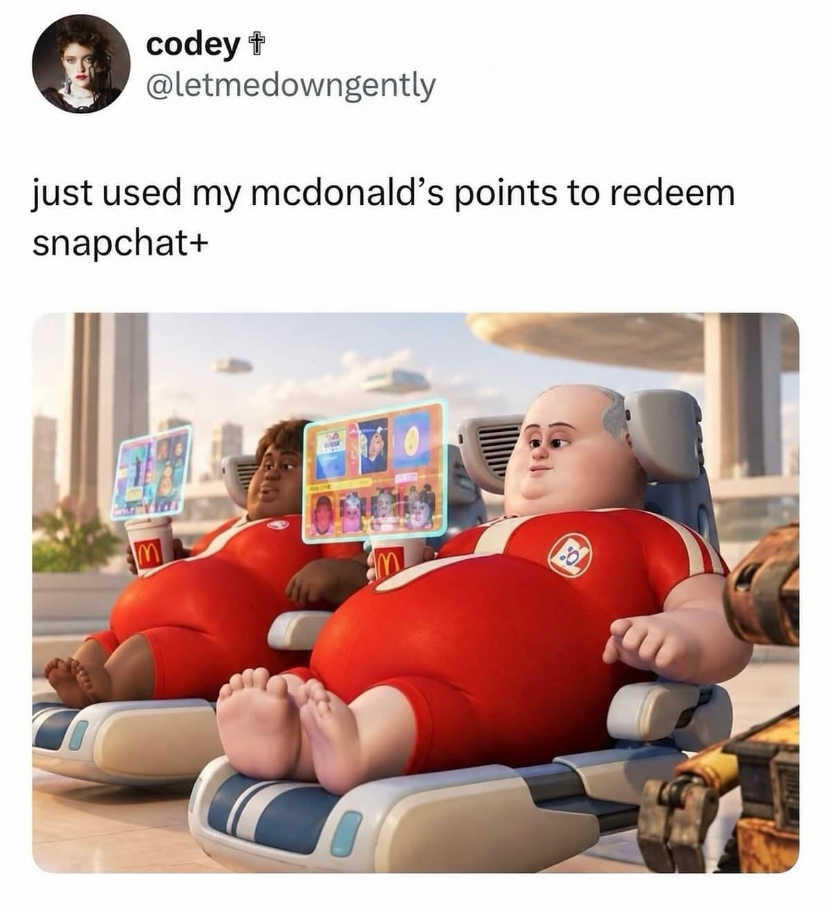 Wall-E humans relaxing on floating chairs with holograms above social media meme text.