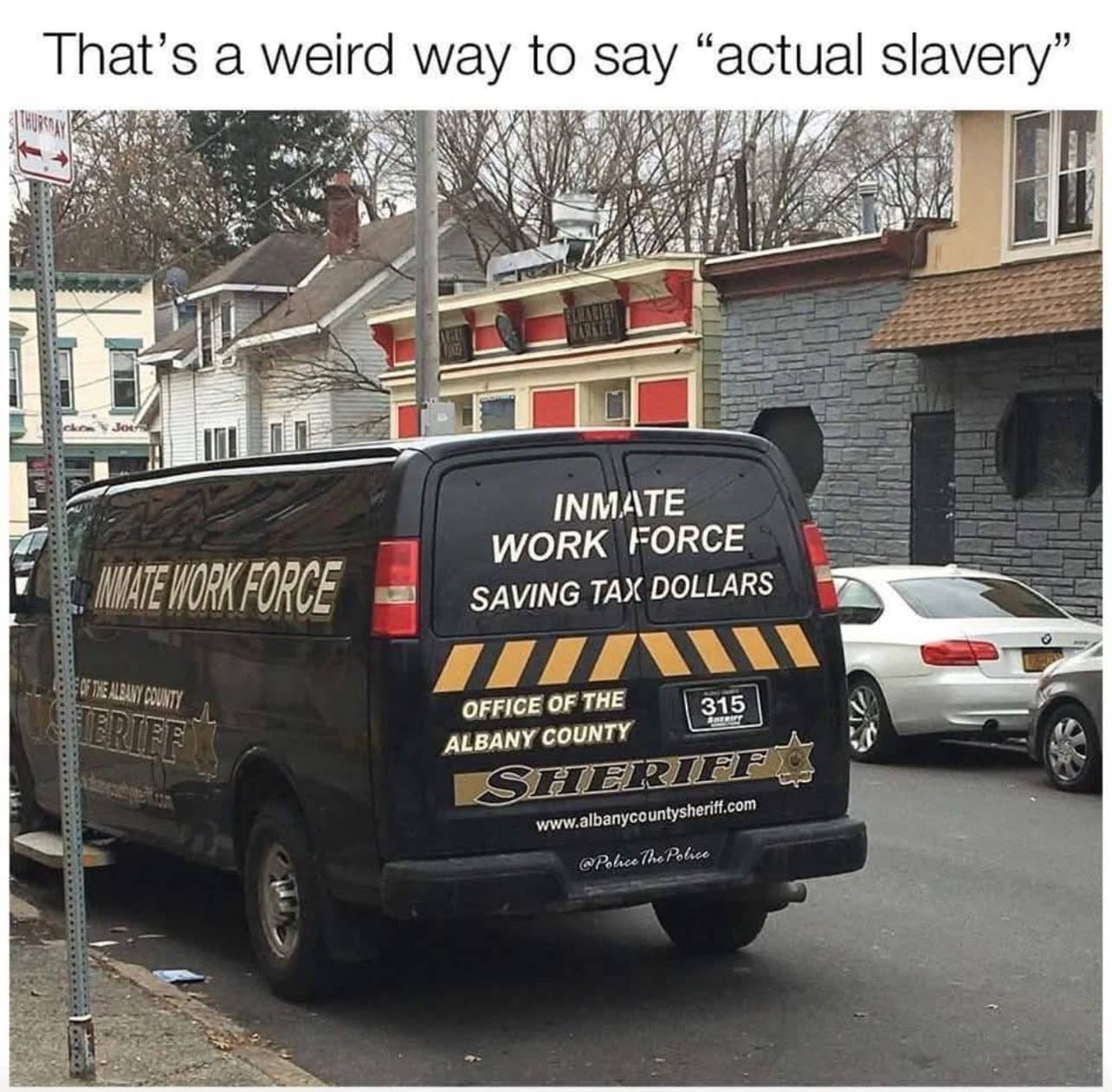 Black sheriff inmate work force van with social commentary joke text above funny meme.