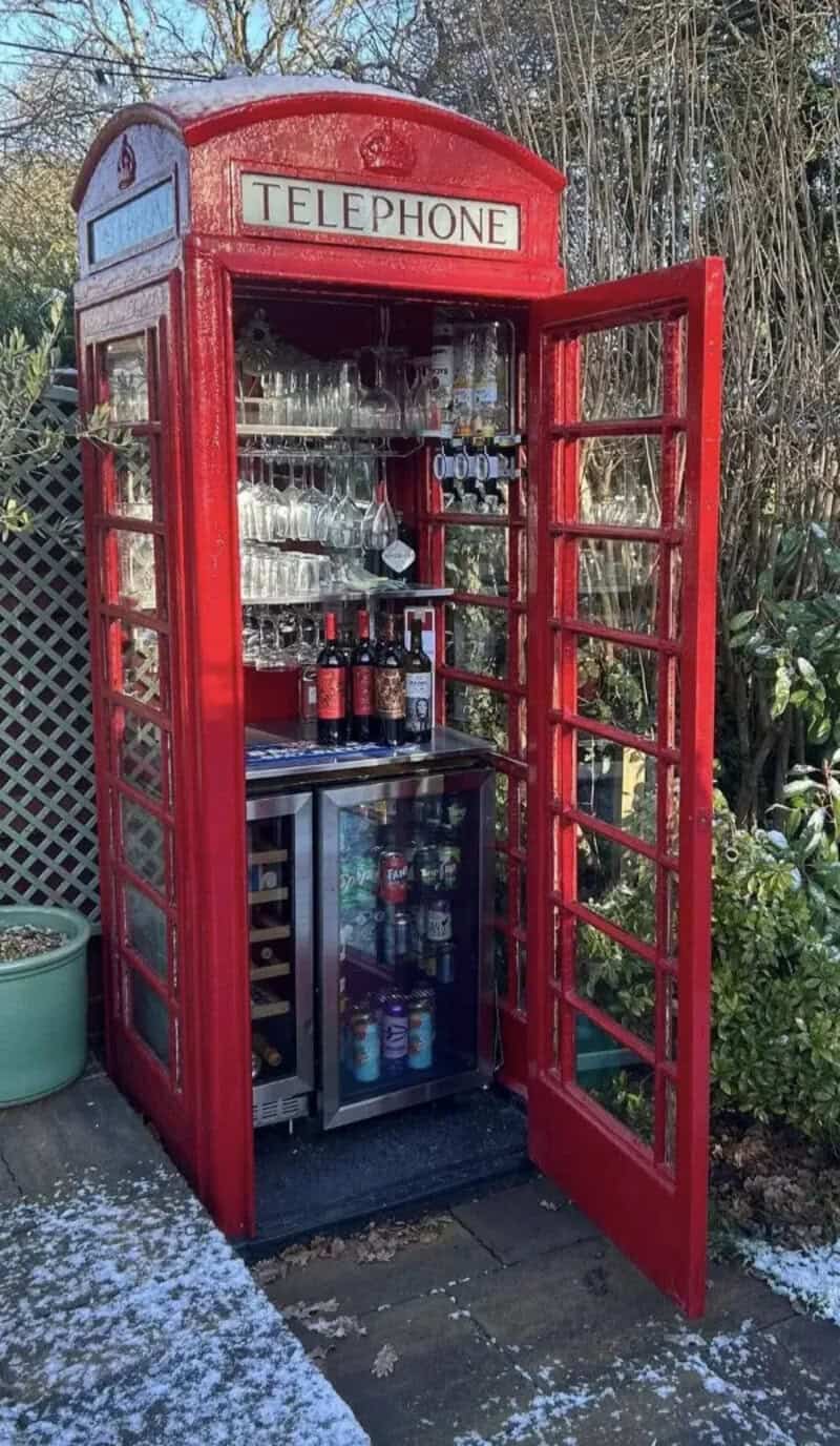 Classic red British telephone box repurposed as outdoor mini bar filled with wine and liquor funny memes