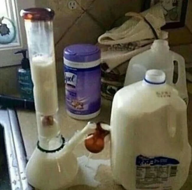 Glass bong filled with white milk next to gallon jug funny memes cursed image setup