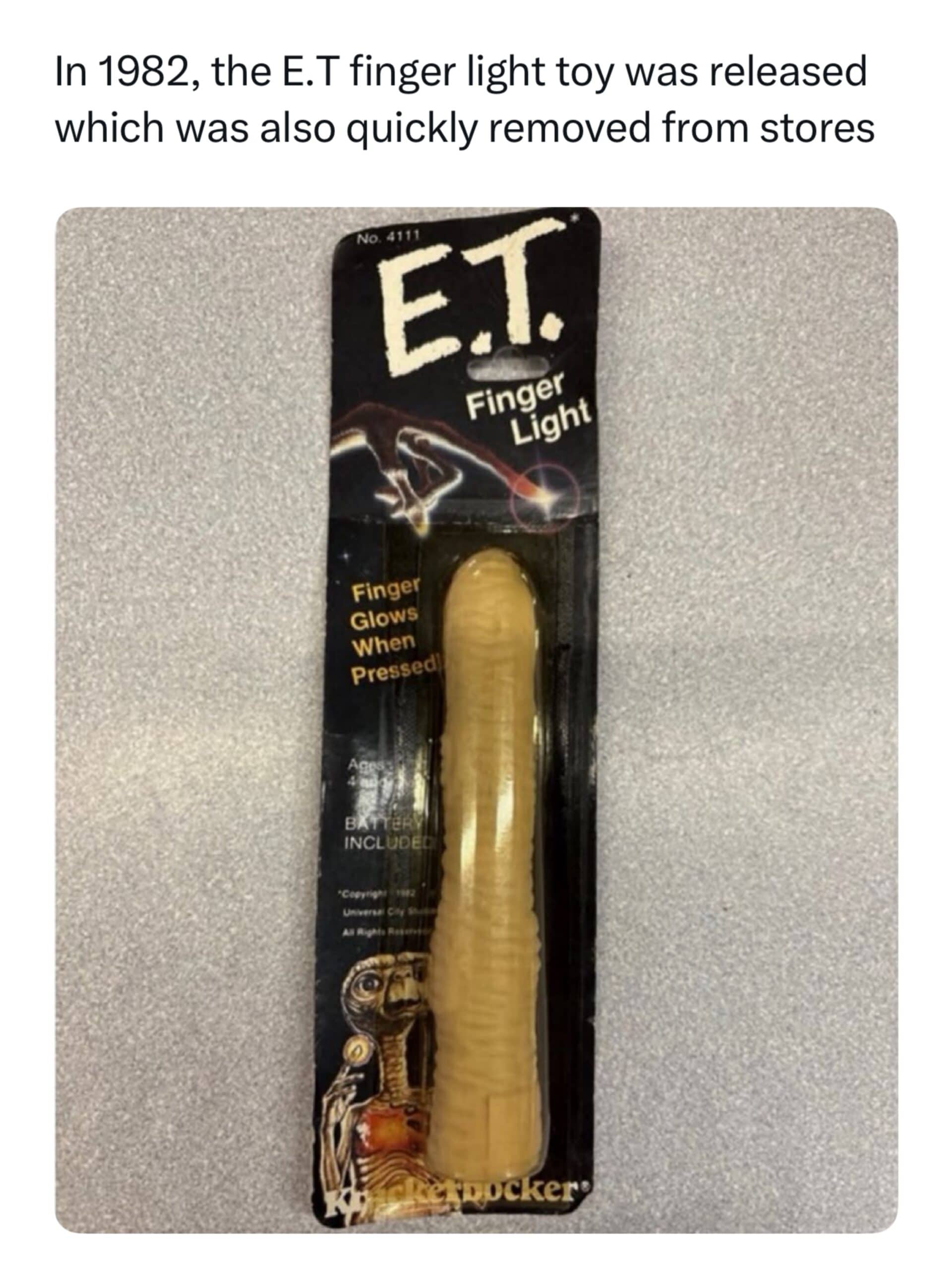 Vintage 1982 ET finger light toy packaged on cardstock with funny unintended shape.