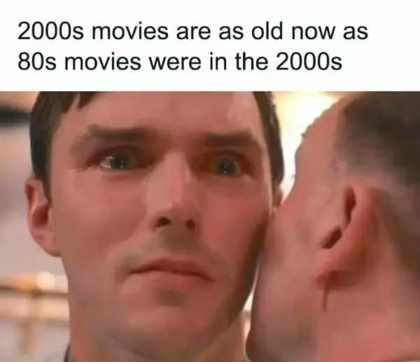 Traumatized man staring ahead in shock as realization dawns about how old 2000s cinema is today in a millennial meme.