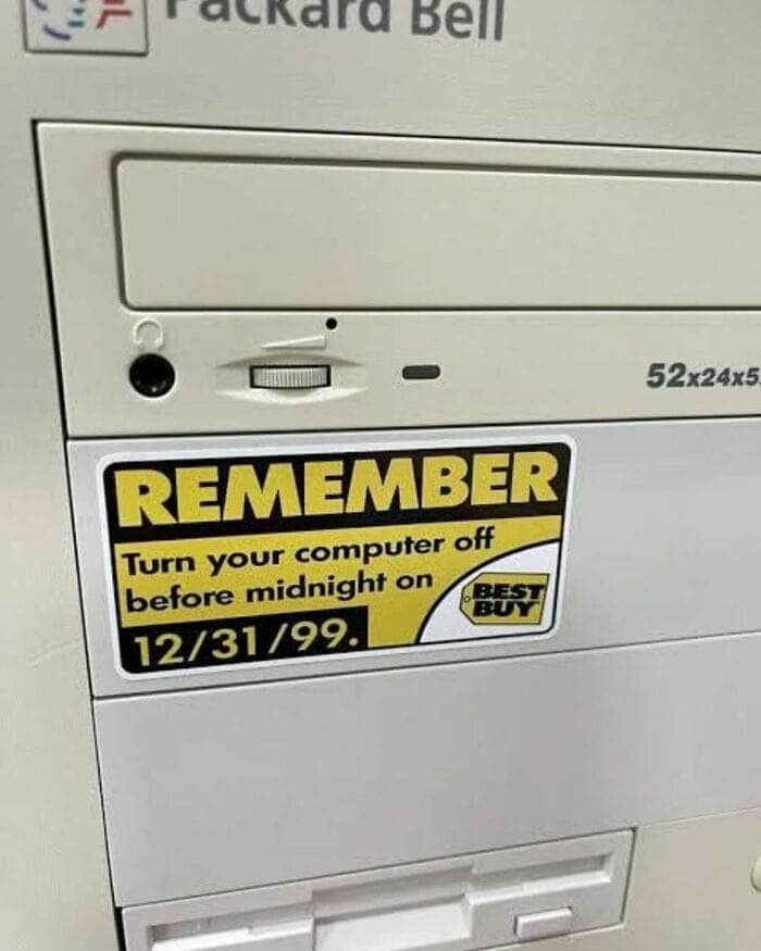 Packard Bell desktop computer tower with a Best Buy Y2K warning sticker to shut off before midnight on 12/31/99 in 90s pics.