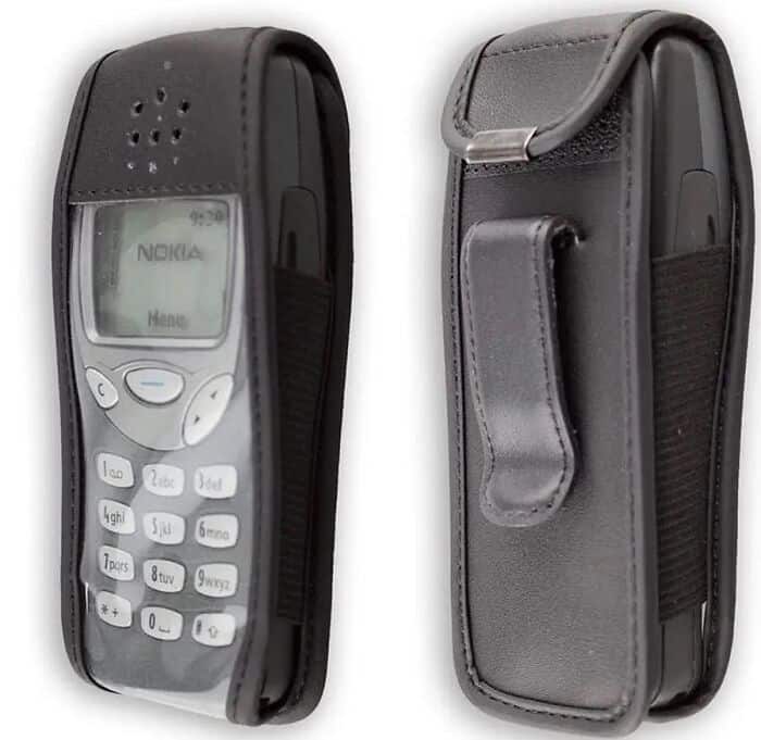 Classic indestructible Nokia brick cell phone encased in a black leather case with a clear plastic screen window in nostalgic images.