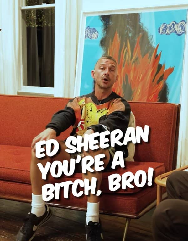 Actor sitting on a red couch with a crude caption insulting Ed Sheeran