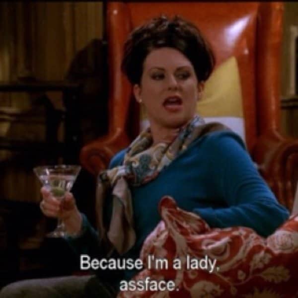 Will and Grace character holding a martini with subtitle calling herself a lady