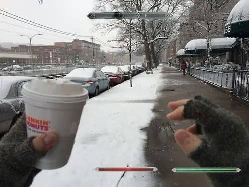 Snowy city sidewalk with a Dunkin' Donuts cup and video game health bars overlaid.