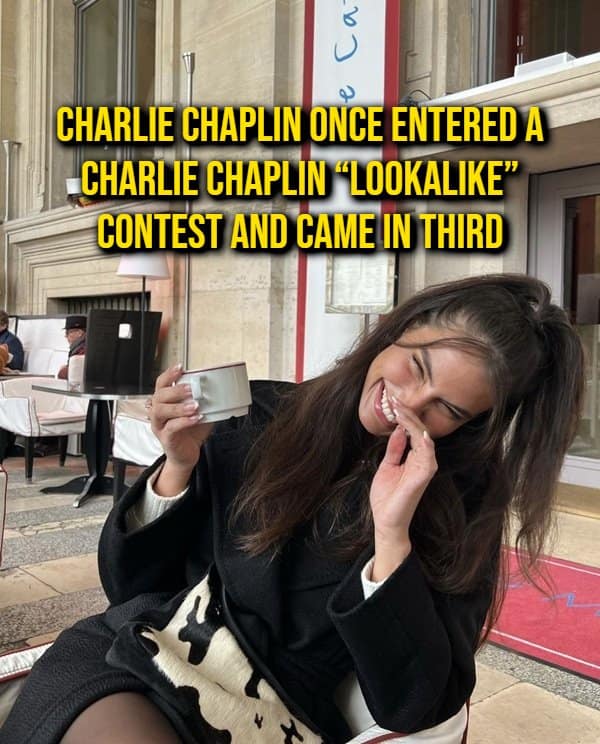 Woman laughing over a coffee cup while reading a random fact about Charlie Chaplin placing third in a Charlie Chaplin lookalike contest.