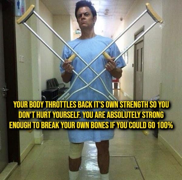 Johnny Knoxville wearing a hospital gown and posing with crossed crutches next to an intense human biology random fact about nervous system muscle limiters.