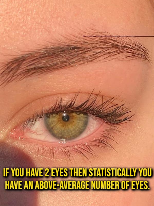 Macro photo of a green eye illustrating a mathematically accurate random fact that having two eyes puts you above the global average.
