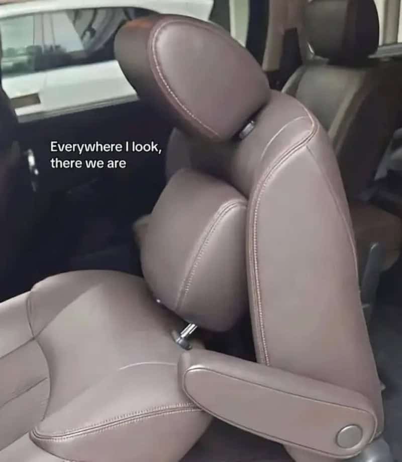 Car seat folded forward so its headrest leans on the seat below like a hug.