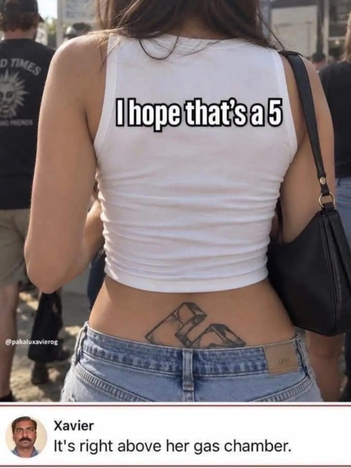 Woman seen from behind in a white crop top, with a blocky lower back tattoo.
