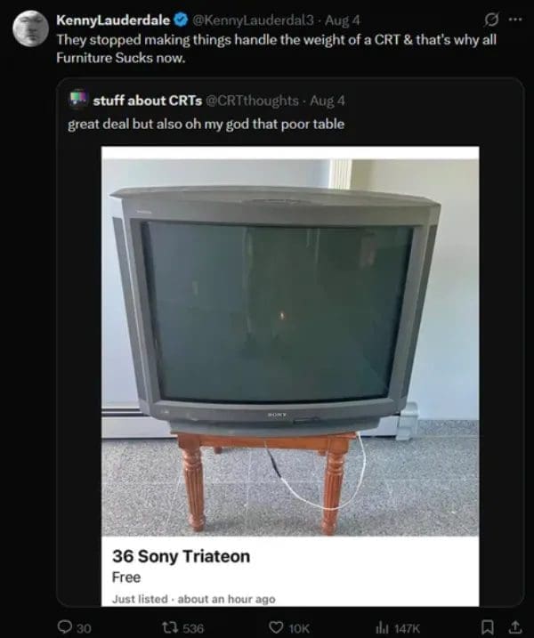 Free giant Sony CRT television balanced on a tiny wooden side table in a listing.