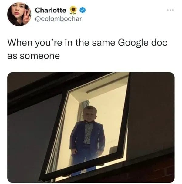 Small man in a suit staring out a lit window, captioned as sharing a Google doc.