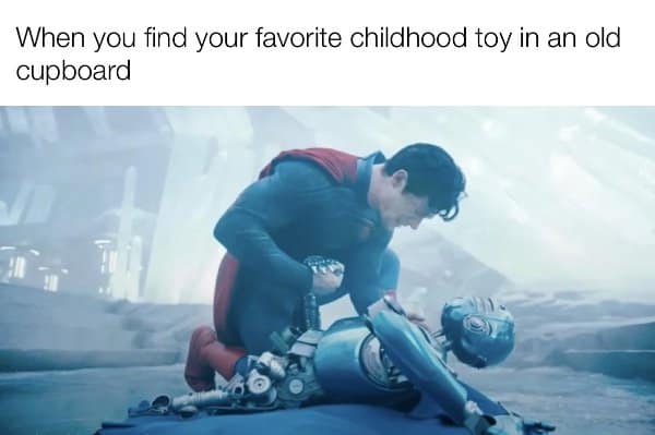 Relatable memes moment of Superman cradling a broken robot like a lost childhood toy.