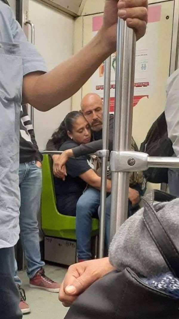 Couple embracing tightly while riding crowded public transit together featured in heartwarming seniors memes.