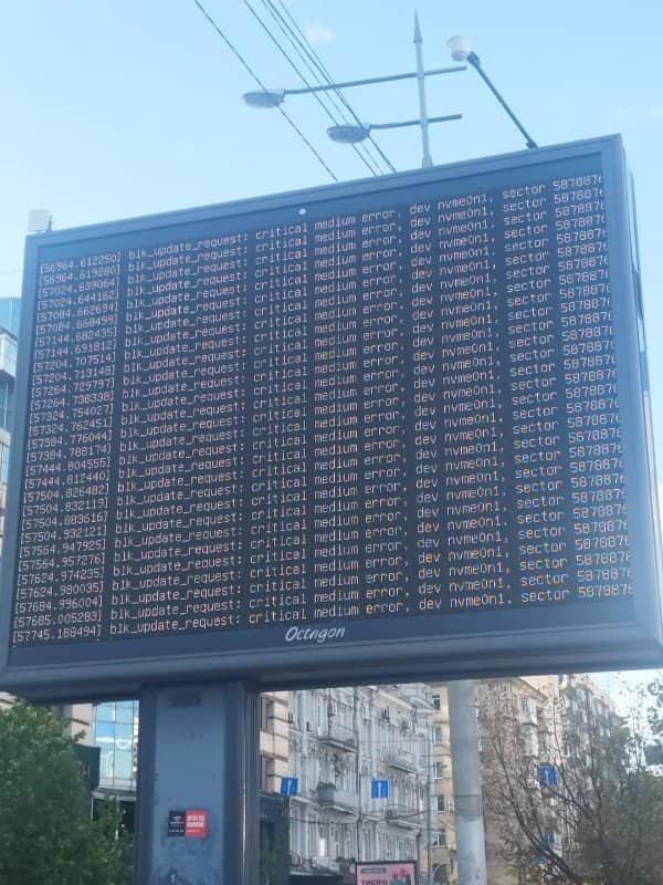 Street billboard displaying a wall of critical medium error messages in terminal text.