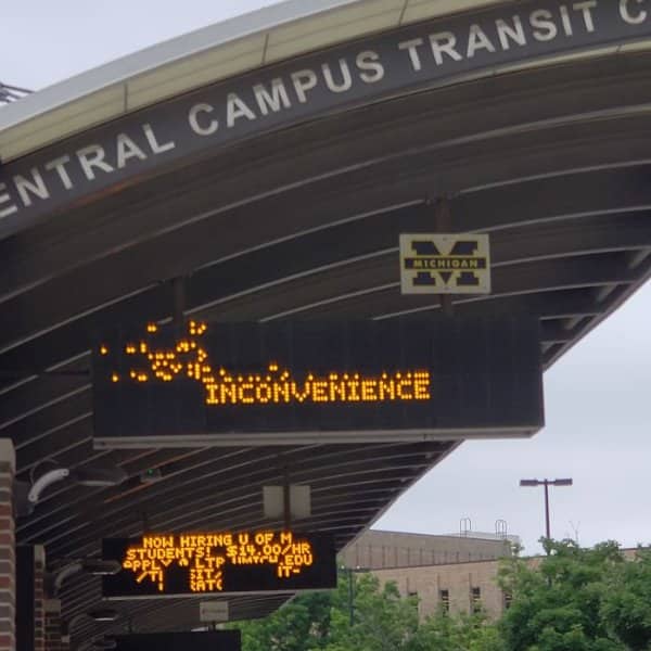 University transit center sign with scrambled lights above the word inconvenience.