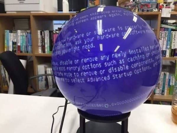 Spherical display globe showing a Windows blue screen of death in an office.