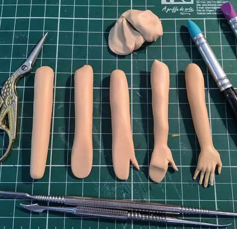 Clay sculpting progression steps skipping from simple cylinder shapes to a realistic sculpted hand.