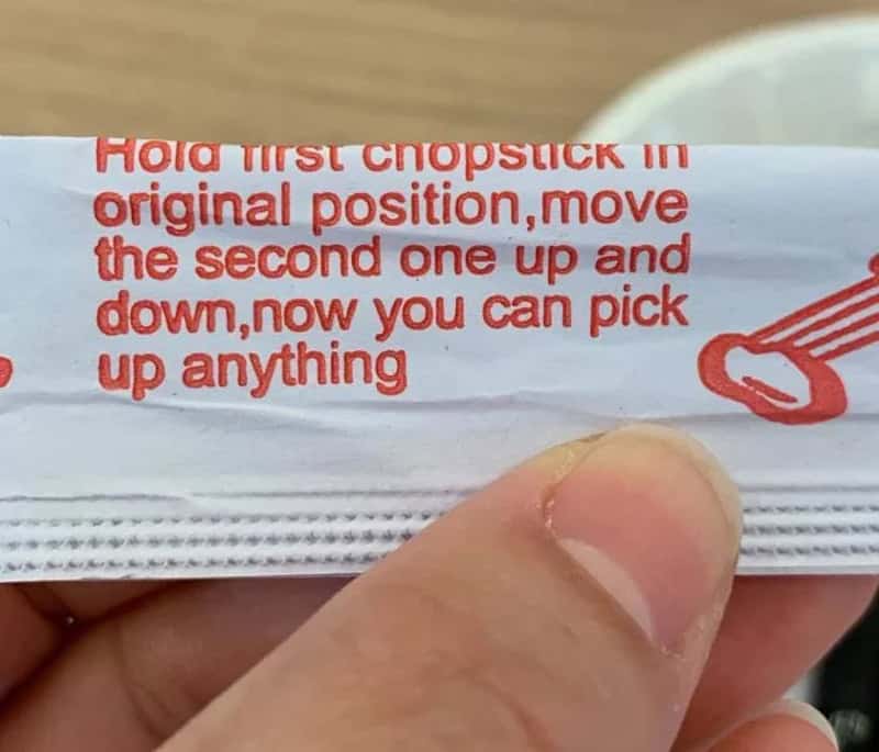 Close-up of chopstick paper wrapper with ridiculously oversimplified instructions on how to pick up anything.