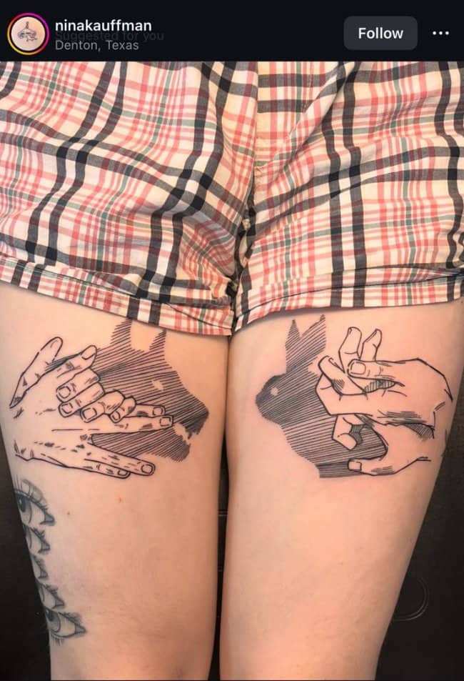 Matching thigh unique tattoos displaying hand shadow puppets of a wolf and a rabbit.